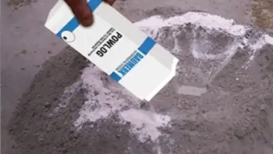 Rozprašování bílého prášku na beton pro zajištění vodotěsnosti.