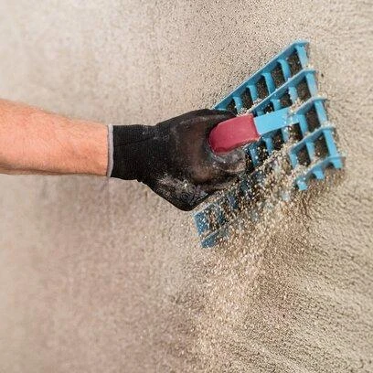 Plastering wall with trowel