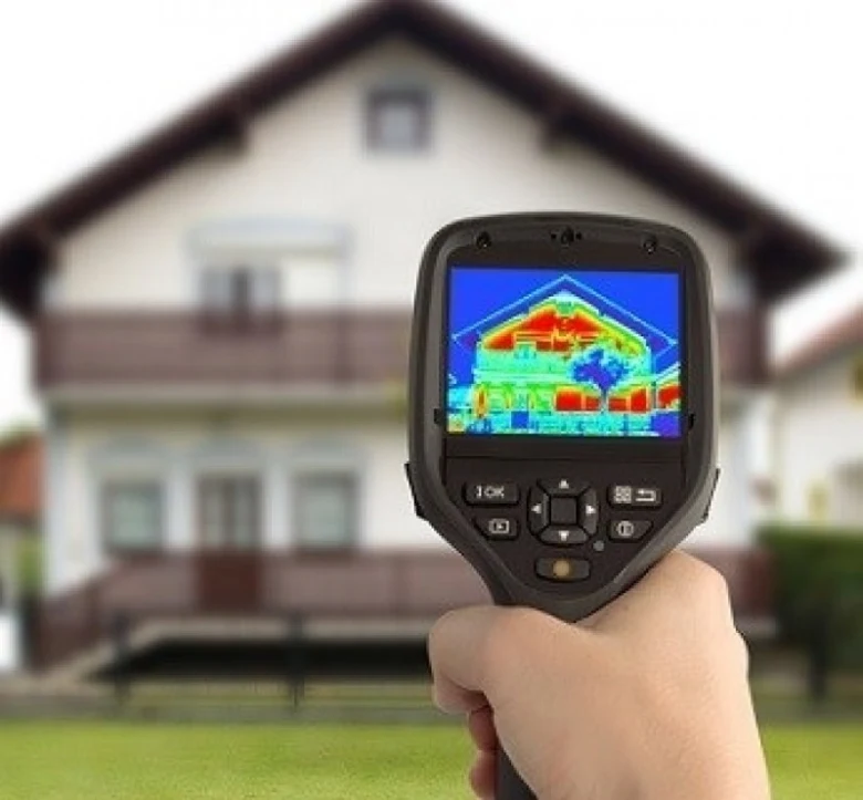 Thermal imaging camera showing house heat loss
