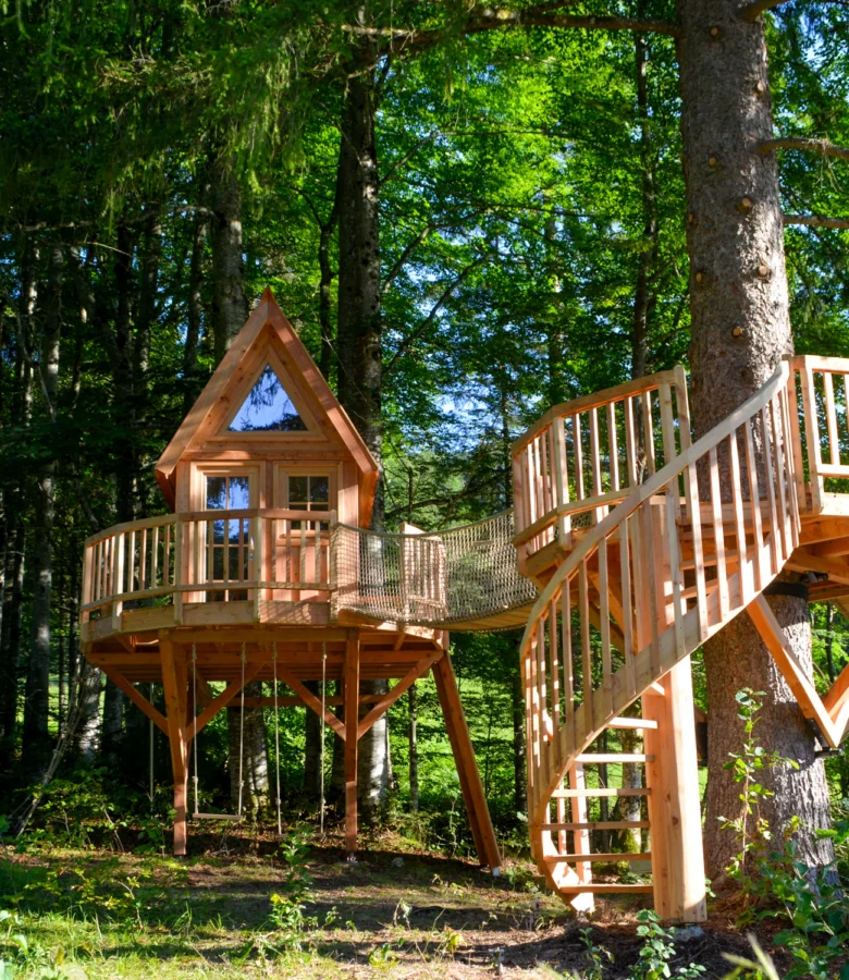 Wooden treehouse with stairs and swing
