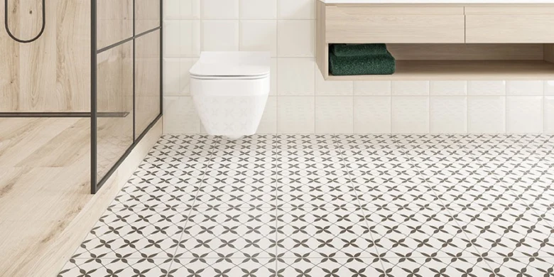 Nově nainstalované dlaždice v koupelně s geometrickým vzorem na podlaze.