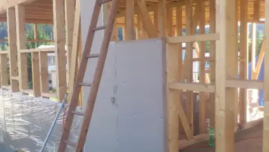 Stodola v dřevěném rámu s instalací izolace na stavbě.