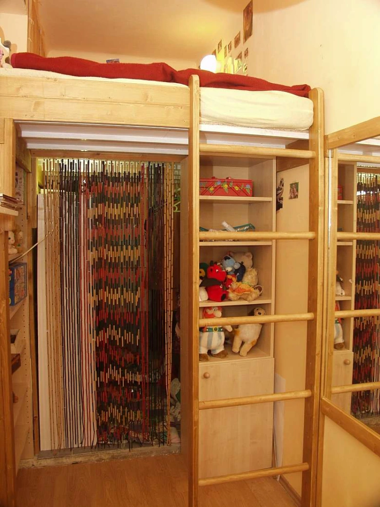 Loftová postel s úložným prostorem pod stropem.