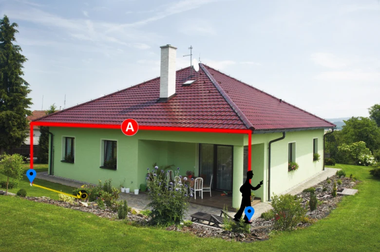 Zelený dům s červenými značkami pro měření přesahu štítu střechy.