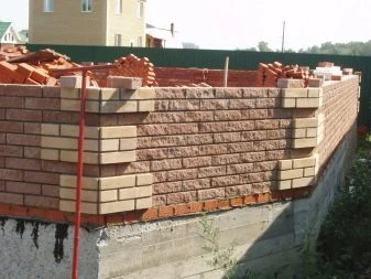 Částečně postavená cihlová zeď na stavebním místě.