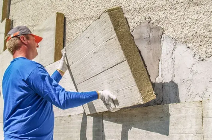 Montáž minerální vaty na fasádu před omítkou.