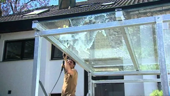Man installing glass canopy