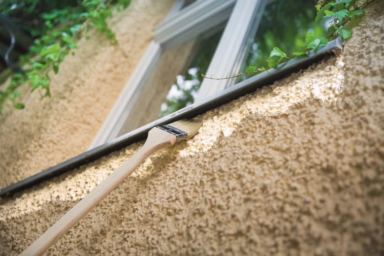 Painting exterior wall with brush