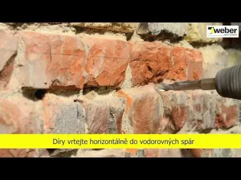 Vrtání do cihlové zdi podél švů pro hydroizolaci.