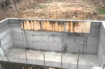 Nezhotovený suterén se zděnými stěnami a výztuží.
